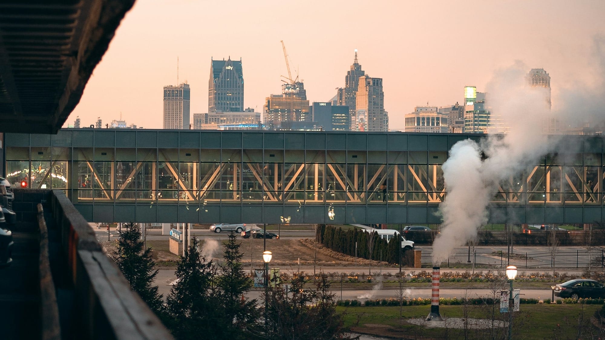 a train traveling over a bridge next to a city